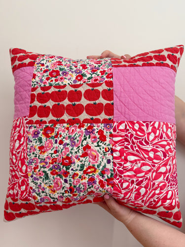 patchwork pillow in pink and red fabrics